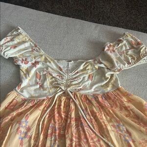 Free People Cream and Orange Floral Top with cap sleeves longer on sides